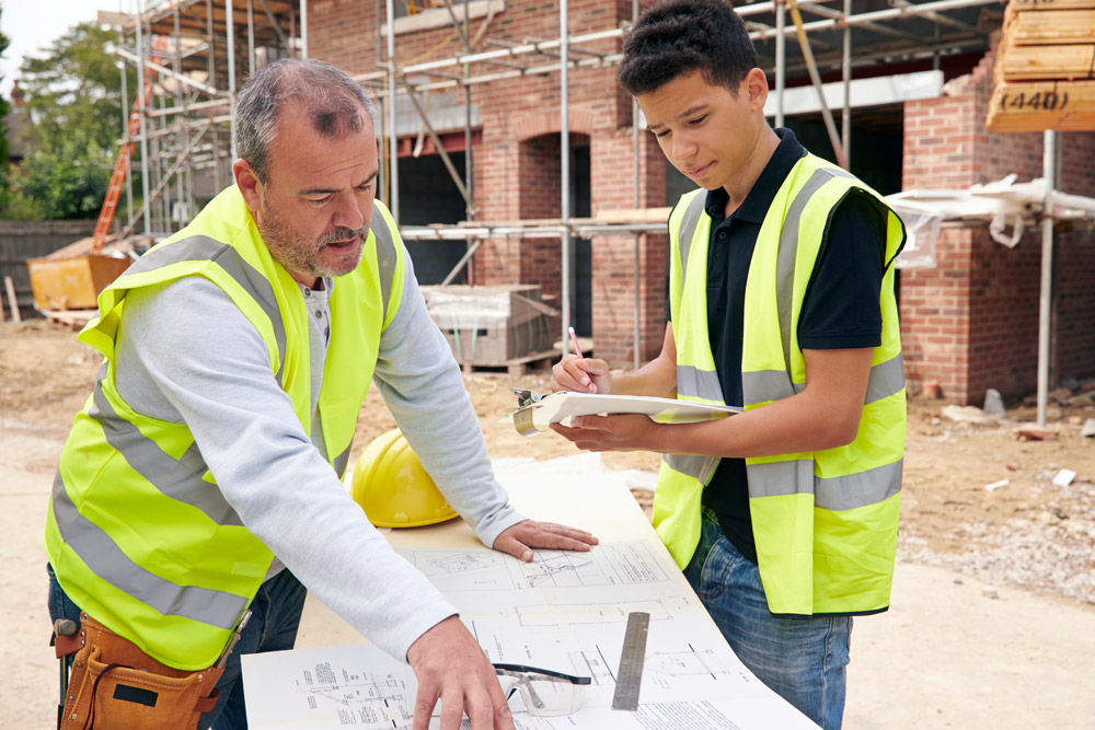 Mentee and mentor working together on construction site